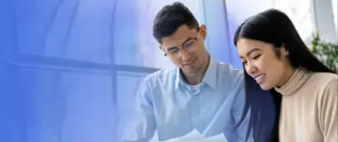 Man and woman working together on laptop – Hays Japan Salary Guide and market insights.