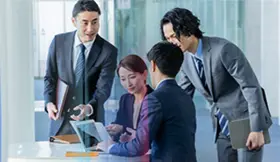 Four business professionals in a meeting discussing ideas and teamwork